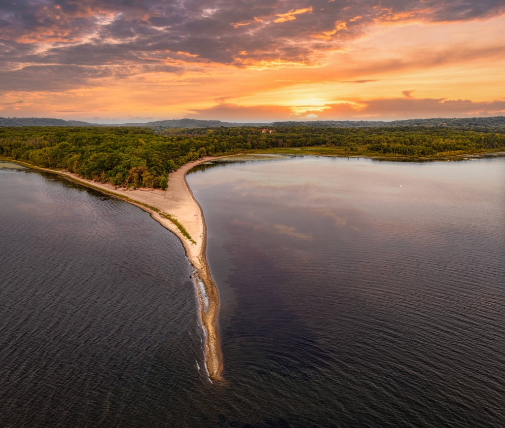 Aerial view of beach and Mississippi river at sunset