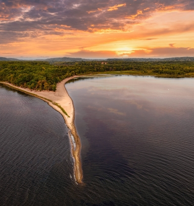 Aerial view of beach and Mississippi river at sunset